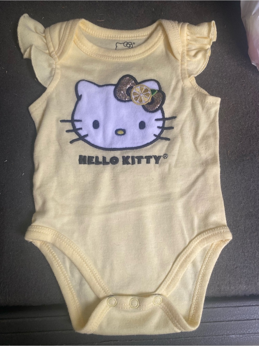 Hello Kitty Pale Yellow Baby Bodysuit with Glitter Bow